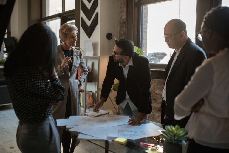 Group of diverse professionals discussing project plans in a well-lit office.